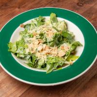 Caesar Salad · Romaine hearts topped with toasted almonds, Parmesan cheese, and Caesar dressing.
