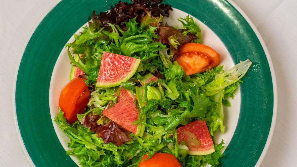 House Salad · Mixed field greens, tomato wedges, celery, and watermelon radishes topped with vinaigrette.

