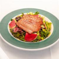 House Broiled Salmon Salad · Mixed field greens, tomato wedges, celery, and watermelon radishes topped with vinaigrette.

