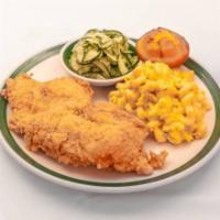 Crispy Fried Chicken  · Fried chicken breast blue plate served with 2 sides and a corn muffin.
