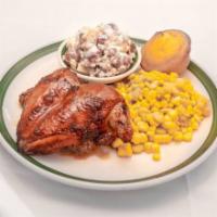 Rotisserie Chicken · Rotisserie chicken breast marinated in lemon pepper tamari, blue plate served with 2 sides, ...