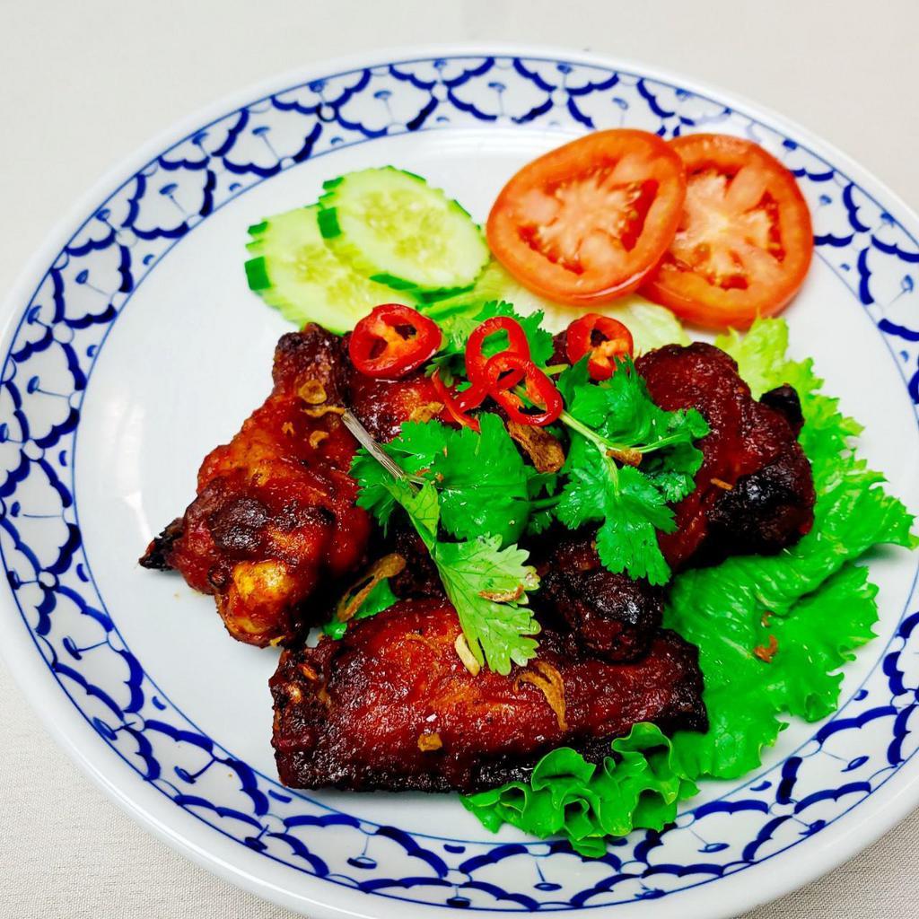 Spicy Chicken Wings · Deep fried marinated tom yum flavor wings with Thai herbs garnished. Spicy