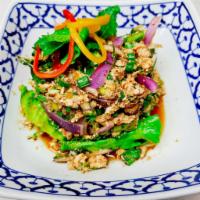 Larb Gai · Spicy Thai chicken salad. Minced organic chicken, chili powder, roasted rice powder, red oni...
