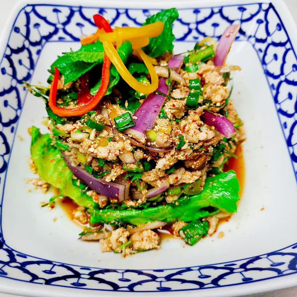 Larb Gai · Spicy Thai chicken salad. Minced organic chicken, chili powder, roasted rice powder, red onion, mint and scallions, with Thai chili-lime dressing. Spicy. Gluten free.