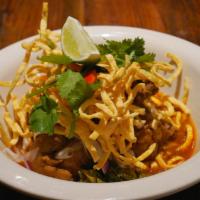 Khao Soy (Noodle Curry) · Braised Chicken thigh, Egg noodle, Beanspout, Pickled mustard green, Red onion and Topped wi...