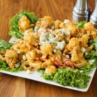 Fried Calamari · Dipped in Maggie's signature housemade buttermilk batter then lightly fried. Served with lem...