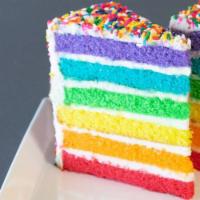 Rainbow Cake Slice · Six layers of rainbow-colored vanilla cake filled high with a sweet vanilla buttercream, cov...