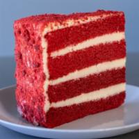 Red Velvet Cake Slice · Red velvet cake filled and decorated with a sweet cream cheese frosting, covered in cake cru...