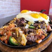El Gordo Skillet · Carne asada, jalapenos, tomatoes, onions, and shredded cheese.