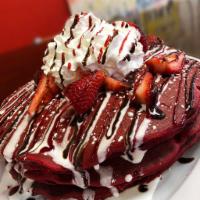 The Lover · Red velvet griddlecakes, strawberries, whipped cream and a raspberry and chocolate drizzle.
