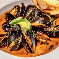 Mussels · Chipotle tomato sauce topped with cilantro, red onion, lime and served with toasted bread.