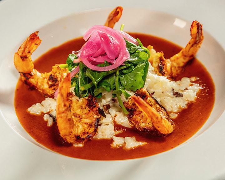Shrimp a la Diabla · 5 grilled spicy jumbo shrimp served with creamy bacon risotto, watercress, red pickled onion and spicy tomato sauce.