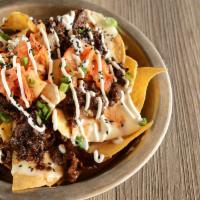 Nachos · Served with corn tortilla chips, choice of protein, queso blanco, OG kimchi, green onion, ro...