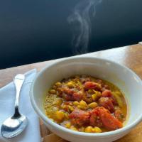 Moroccan Stew · Organic tomatoes slow cooked with fresh ginger, spice, and chickpeas over Arkansas organic b...