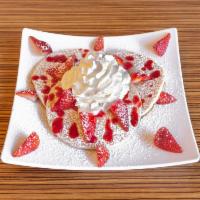 Strawberry Pancakes · Short stack with strawberries, powder sugar and whip cream.