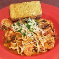 Linguini with Shrimp · Linguini pasta, shrimp, mushrooms, capers, cilantro, garlic, red sauce and Parmesan cheese.
