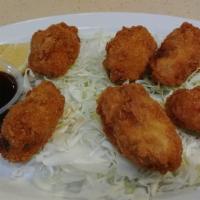 Fried Oyster (6 Pieces) · Deep-fried breaded oysters. Served with ponzu sauce and a lemon slice.