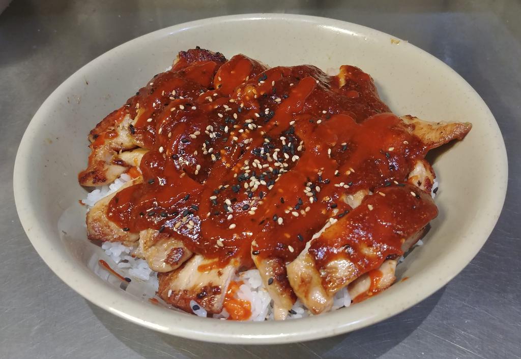 Spicy Chicken Teriyaki Donburi · Grilled boneless chicken over steamed rice with spicy teriyaki sauce and sesame seeds. Served with miso soup and salad.