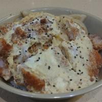 Katsu Don · Deep-fried pork scrambled with eggs and onions with sesame seeds over steamed rice. Served w...