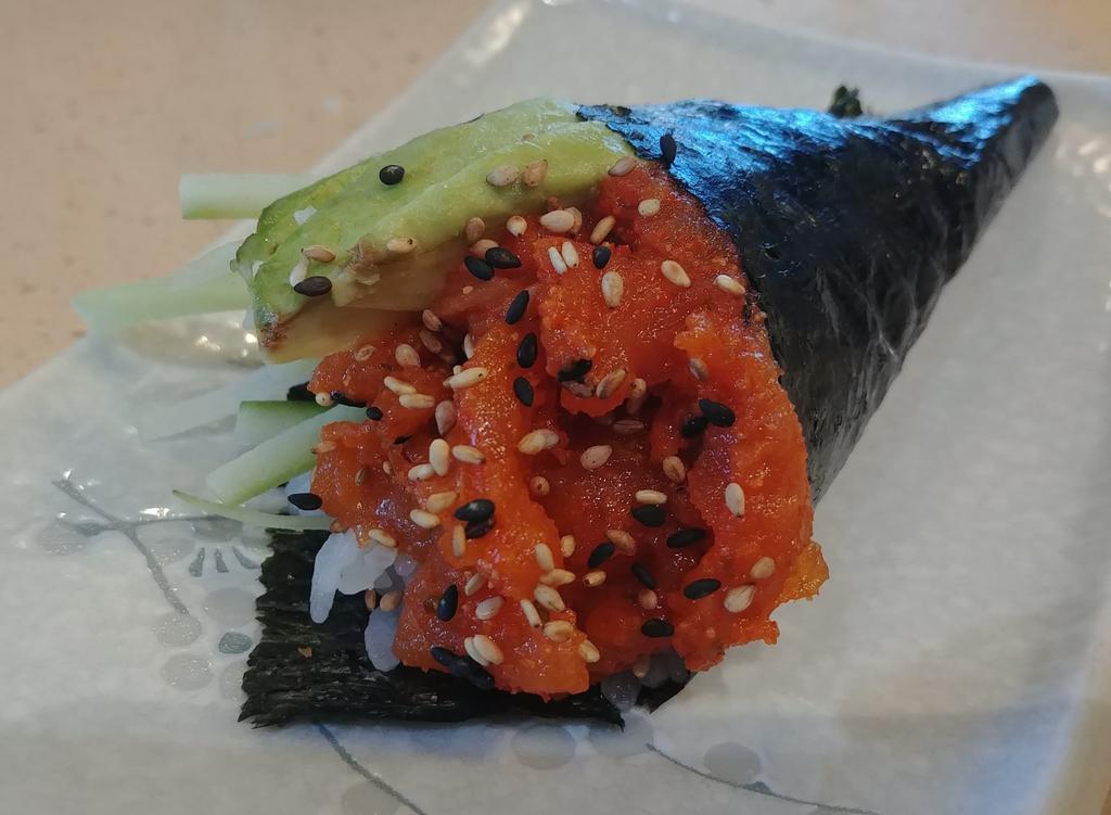Spicy Salmon Hand Roll · Spicy salmon, avocado, cucumber, sushi rice, seaweed, sesame seeds.