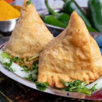 2 Pieces Vegetable Samosa · 2 deep fried triangular shape pastry stuffed with mildly spiced potatoes, green peas and gar...