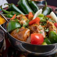 Kadai Chicken · Chicken cooked with onion, tomatoes, bell peppers and flavored with spices.