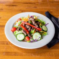 Steak Salad · Sliced grilled beef tenderloin served with shallot vinaigrette. Mixed greens, cabbage, shred...