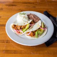 Cochinita Pibil Tacos · Shredded pork loin cooked yucatan-style with achiote topped with avocado and vinaigrette oni...