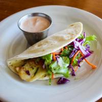 Fish Tacos · Grilled tilapia in delicate garlic sauce, lettuce, cabbage, and carrots served with chipotle...