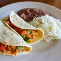 Soft Tacos · Choice of shredded chicken or ground beef, lettuce, tomato, and cheese. Served with rice and...