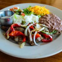 Beef Fajitas · Marinated beef, grilled with onions and bell peppers. Served with rice, beans, pico de gallo...