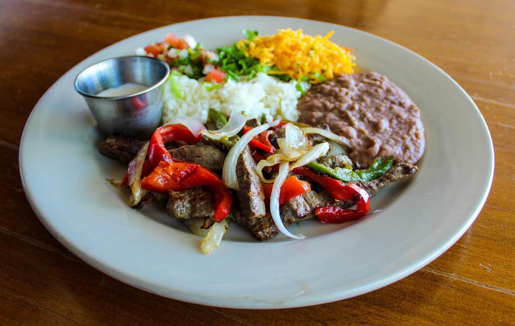 Beef Fajitas · Marinated beef, grilled with onions and bell peppers. Served with rice, beans, pico de gallo, fresh salsa, sour cream and cheddar cheese. We recommend flour tortillas.