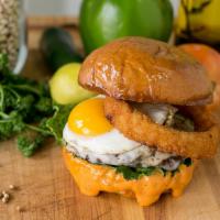 Zuzu's Burger · Handmade beef patties, Provolone cheese, Romaine Lettuce, Fried Egg, Onion Ring, Chipotle Tr...