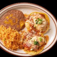 Huevos Rancheros Breakfast · 2 crispy corn tortillas topped with with sunny side up eggs and red chunky tomato sauce and ...