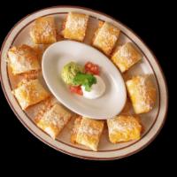 Chicken Taquitos · Rolled crispy flour tortilla stuffed with shredded chicken and cheese topped with sour cream...