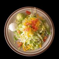 Tostadas Salad · Crispy flat corn tortilla shell topped with beans, lettuce, your choice of meat. Served with...
