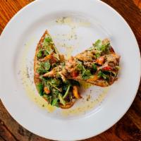 Bell Pepper Bruschetta · Roasted bell peppers, arugula, capers, and garlic over a roasted sourdough bread slice.