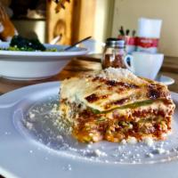 Lasagna alla Bolognese · Traditional bolognese sauce and homemade bechamel layered in egg dough pasta and baked in th...
