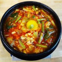 Tofu Stew Soup (Soondubu) · Traditional Korean tofu stew with silken tofu, egg, chili paste and assorted seafood. Served...