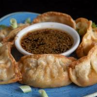Vegetable Mandu Dumpling · Fried dumplings filled with edamame and vegetables, served with a sesame soy sauce. (6 pieces)
