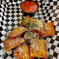 Toasted Ravioli · A St. Louis classic stuffed with cheese. Served with house-made marinara sauce.