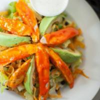 Buffalo Chicken Salad · A bed of romaine topped with black beans, shredded cheddar cheese, avocado, tortilla strips,...