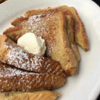 French Toast · Made with thick egg bread and topped with powdered sugar and whipped marscarpone.