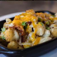 Chowder Tots · Tater tots topped with melted cheddar cheese, bacon bits, green onions and a scoop of our fa...