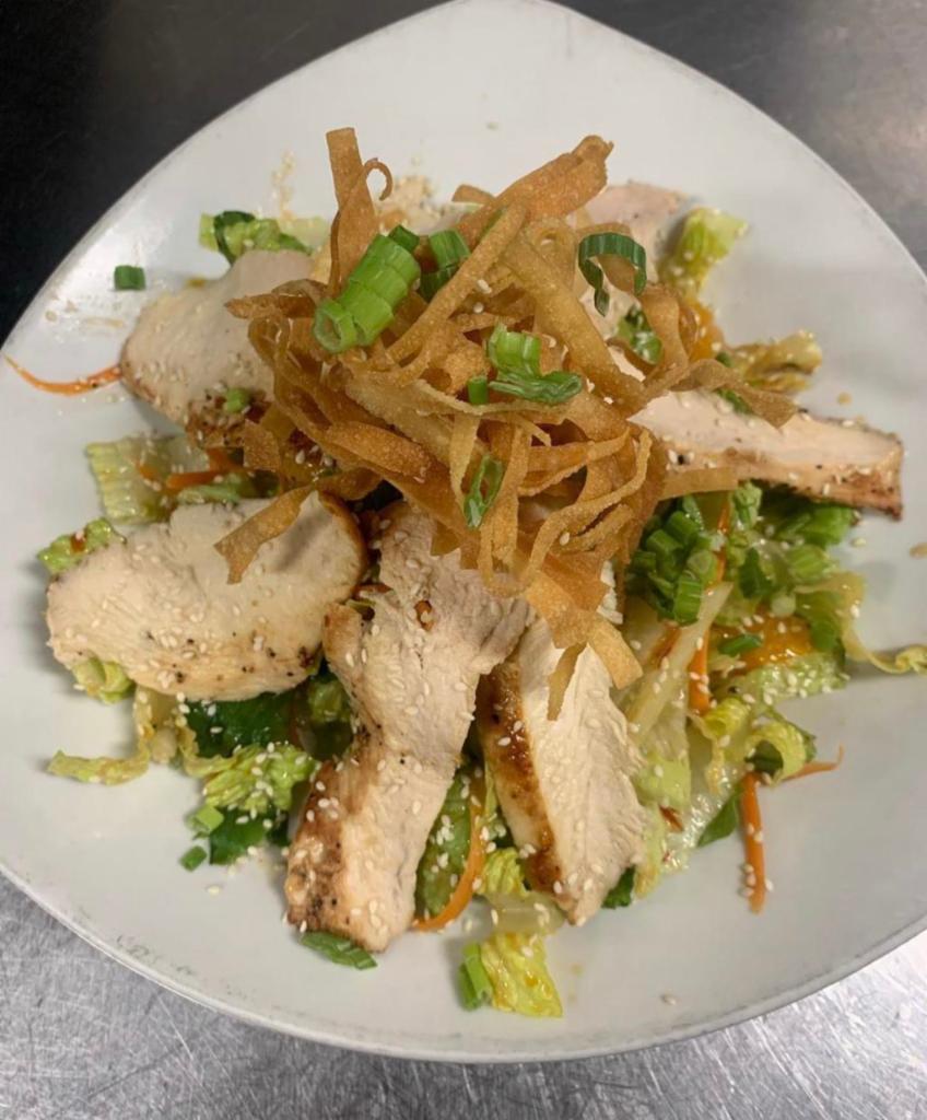 Chinese Chicken Salad Lunch · Crisp romaine lettuce, grilled chicken breast, celery, and a toasted sesame dressing topped with mandarins and crispy fried wontons.