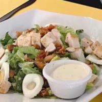 Cobb Salad · Romaine lettuce, bacon, tomatoes, egg, avocado, blue cheese crumbles, choice of chicken or t...