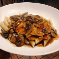 Chicken Marsala · Grilled chicken breast served over penne pasta with a Marsala wine and mushroom sauce.