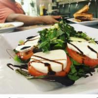 Caprese Salad · Fresh Buffalo mozzarella, tomatoes, and basil drizzled with olive oil and a balsamic reducti...