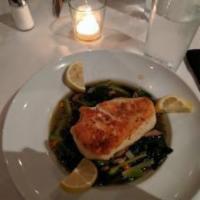 Pan-Roasted Chilean Sea Bass · Served with baby vegetables and seasoned mushroom broth.