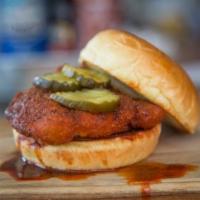 Nashville Hot Chicken · Fried chicken breast, teds bread and butter pickles on a brioche bun drizzled with spicy pep...